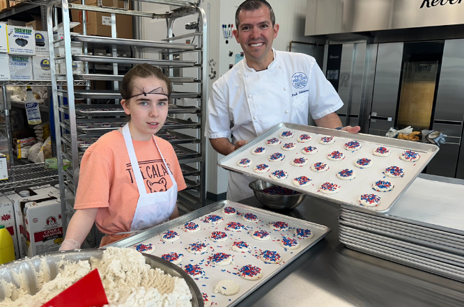 Abby G, above with Two Fields Bakeshop owner Nick Nikolopoulos, prepares a shipment of cookies for Somerset Patriots Stadium